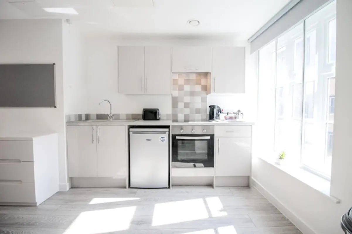 Modern white kitchen with oven toaster and fridge kitchen at Stanley House Nottingham in Nottingham Student Accommodation