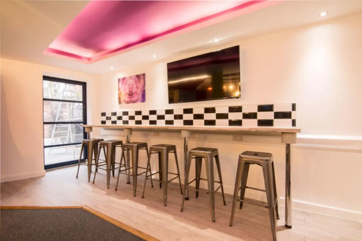 Bar stools with counter and TV area living room at Stanley House Nottingham in Nottingham Student Accommodation