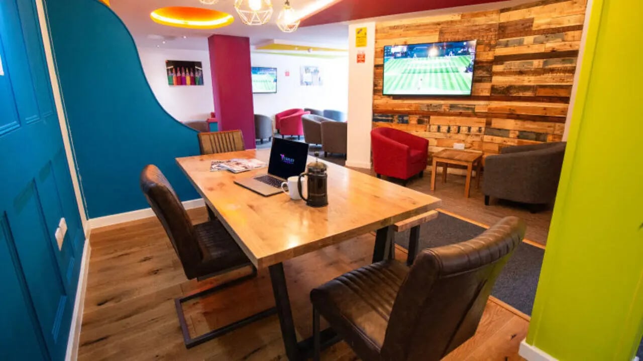 Table with laptop and chairs common area at Stanley House Nottingham in Nottingham Student Accommodation