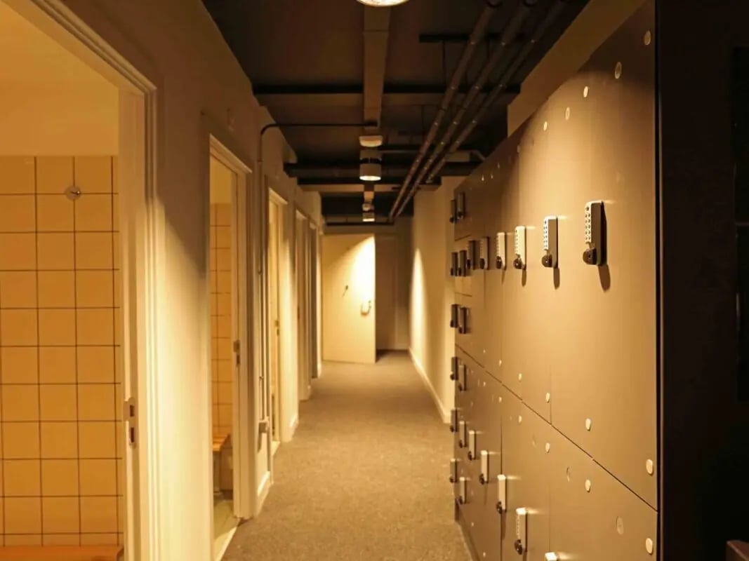 Hallway with lockers and tiled showers hallway at True Birmingham in Birmingham Student Accommodation