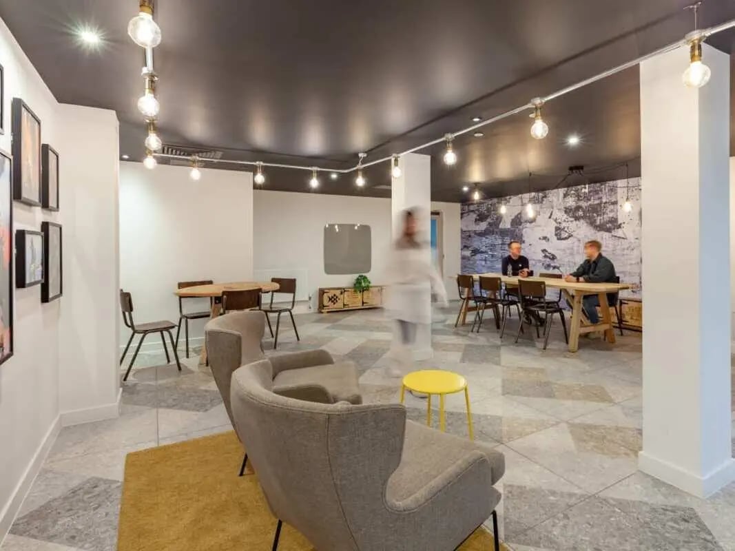 Seating area tables chairs and people common area at True Birmingham in Birmingham Student Accommodation