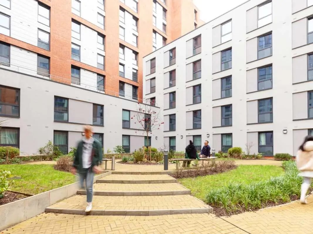 Modern courtyard with people and buildings exterior at True Birmingham in Birmingham Student Accommodation