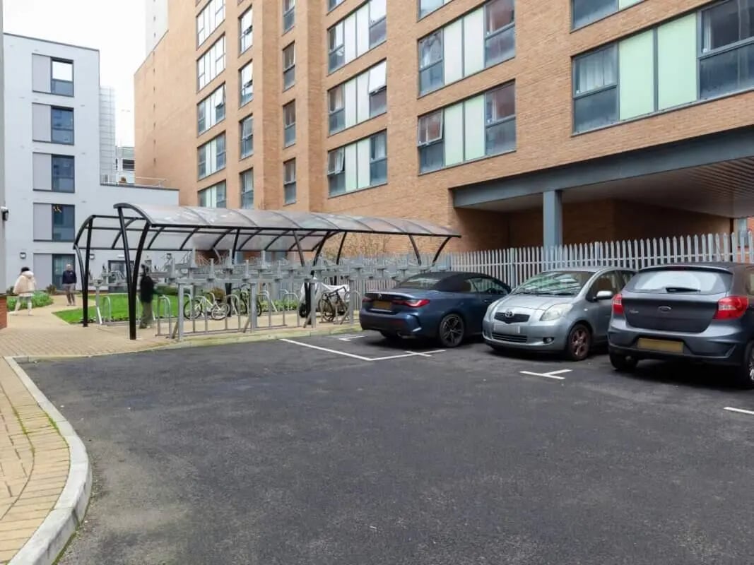 Bicycles and cars parked outside accommodation exterior at True Birmingham in Birmingham Student Accommodation