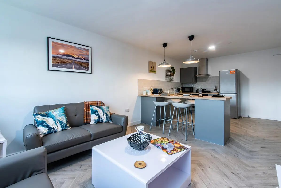 Sofa kitchen island and appliances living area at Broadgate House Student Living in Nottingham Student Accommodation
