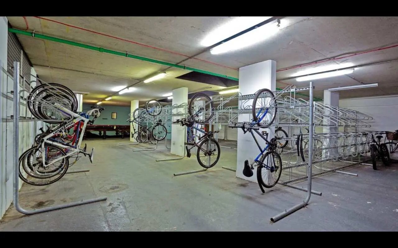 Bikes in racks parking area. Bike storage room. at Griffon Studios in London Student Accommodation