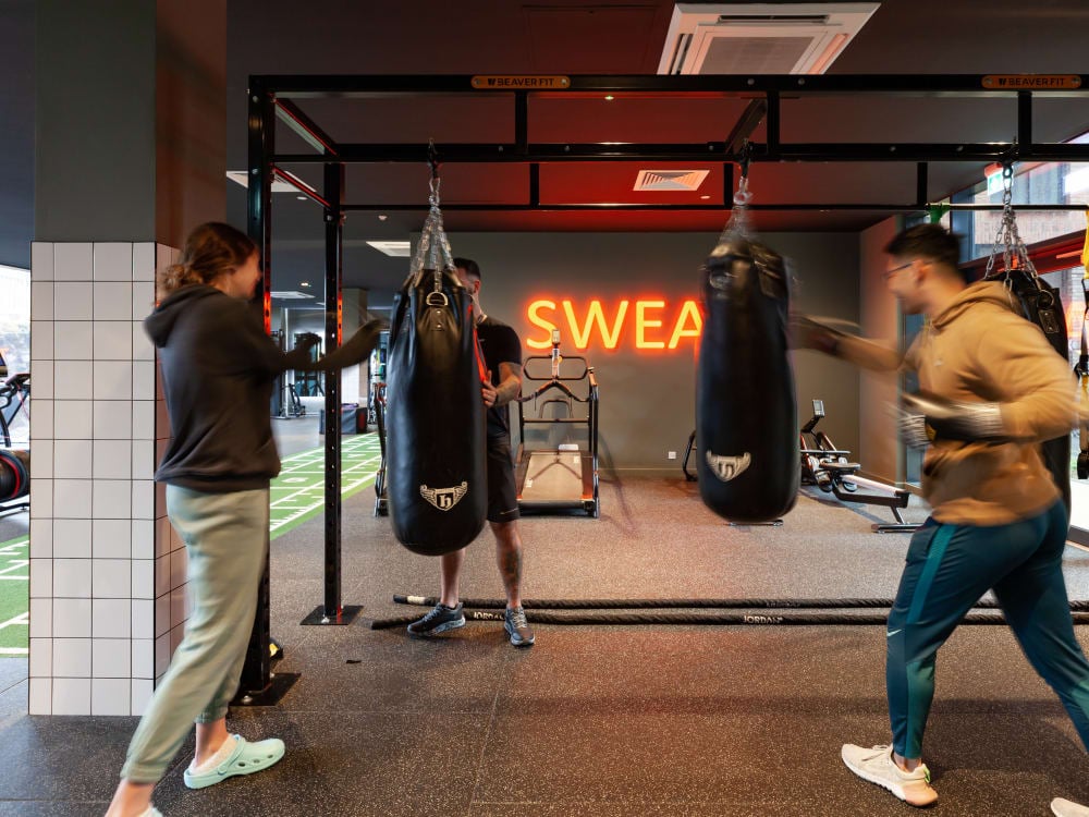 People boxing punching bags gym area at True Liverpool in Liverpool Student Accommodation