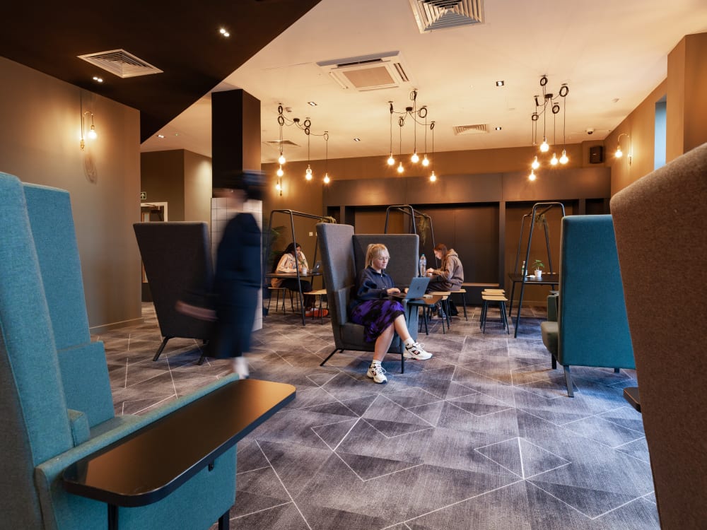 Modern common area with seating and laptops Study area at True Liverpool in Liverpool Student Accommodation