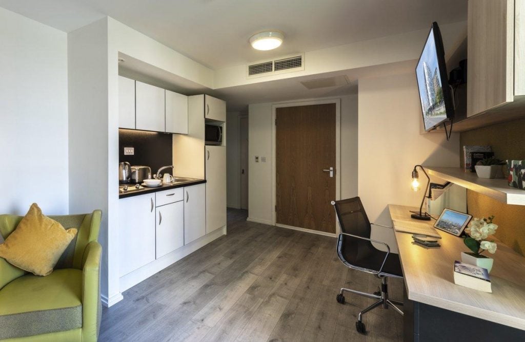 Kitchen study area with chair and desk living room at The Lyra in London Student Accommodation