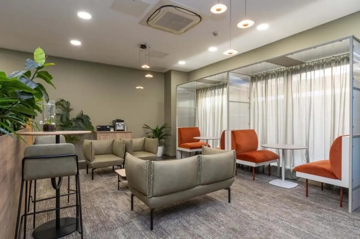 Modern communal area with sofas chairs and coffee station lounge at The Lyra in London Student Accommodation