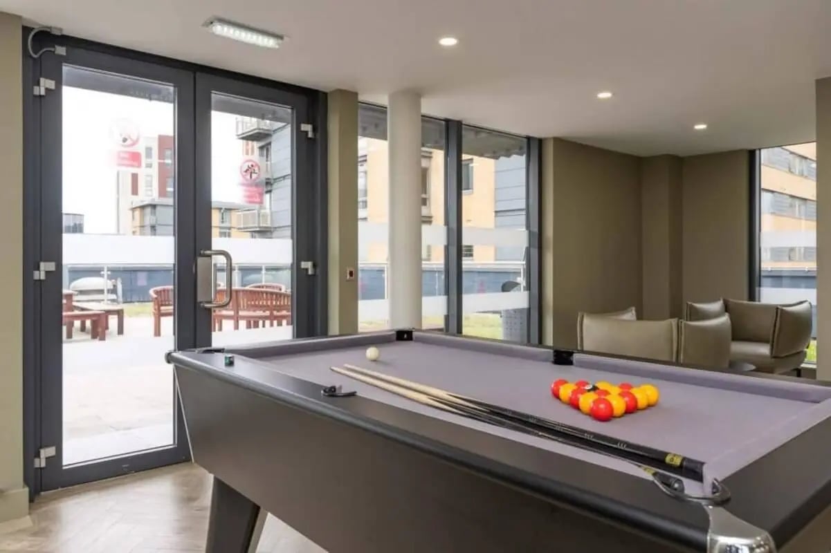 Pool table with balls and cues Game Room at The Lyra in London Student Accommodation