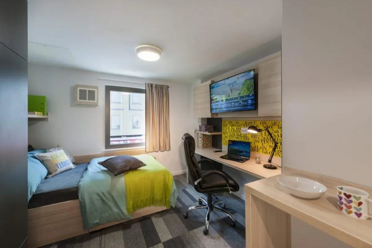 Bed desk with laptop TV chair bedroom at The Railyard Cambridge in Cambridge Student Accommodation