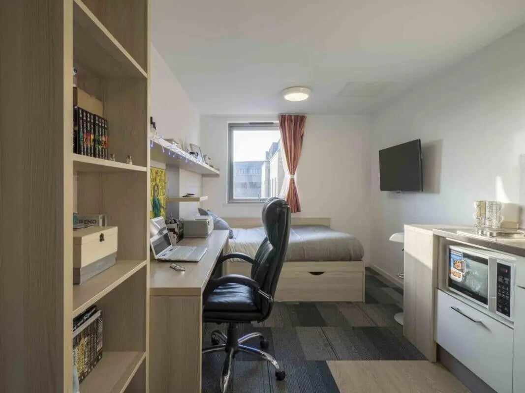 Bed desk chair microwave shelf student room at The Railyard Cambridge in Cambridge Student Accommodation