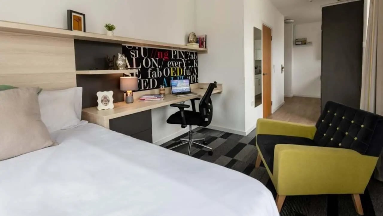 Bed desk chair and armchair student accommodation room at The Arch - Liverpool in Liverpool Student Accommodation