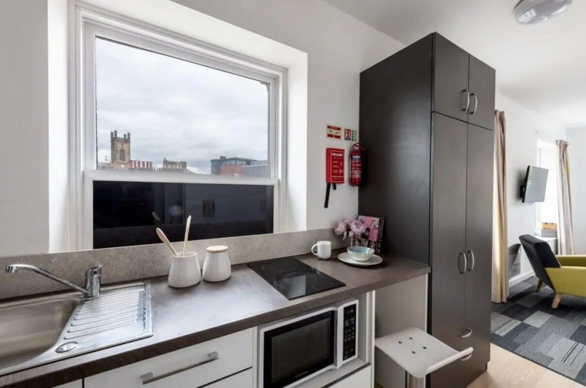 Sink microwave cabinets and oven kitchen area at The Arch - Liverpool in Liverpool Student Accommodation