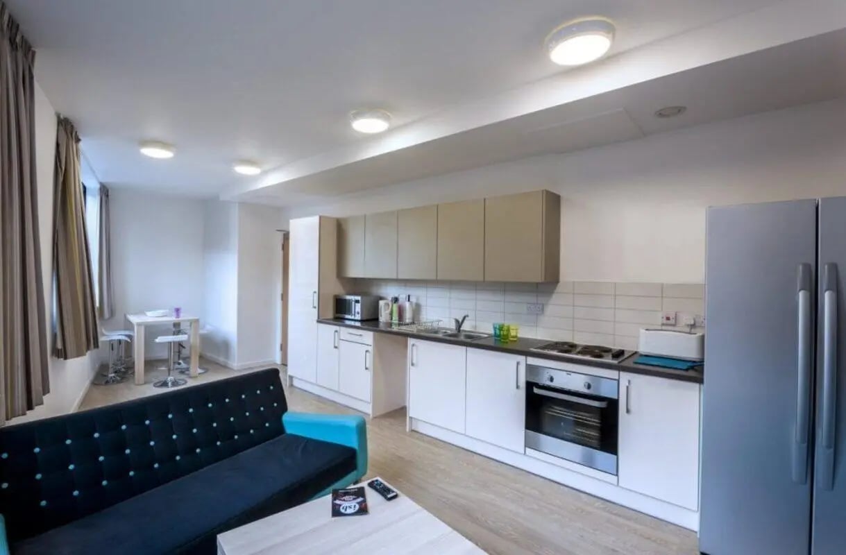 Sofa kitchen table with stools and appliances kitchen at The Arch - Liverpool in Liverpool Student Accommodation