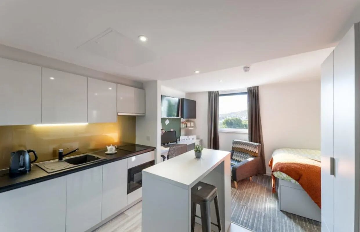 Kitchen counter sink chairs bed and desk study area at New Park in Edinburgh Student Accommodation