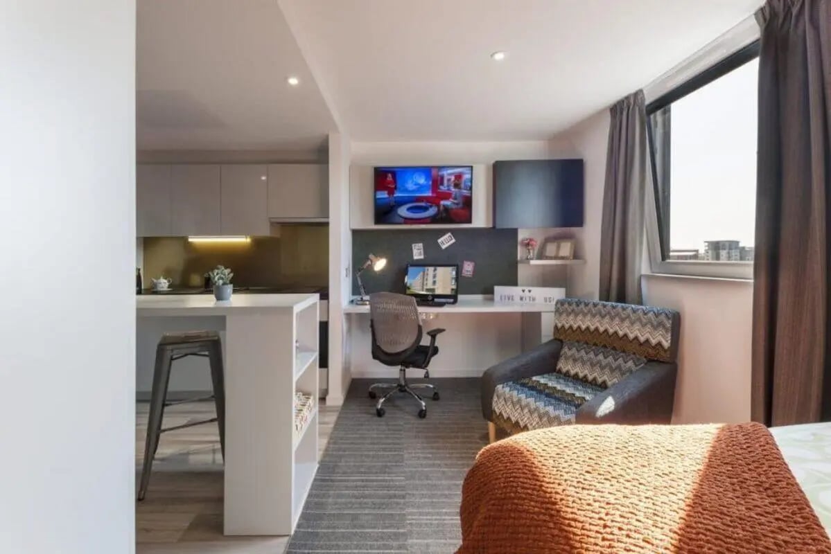 Desk chair computer chair bed with blanket living room at New Park in Edinburgh Student Accommodation