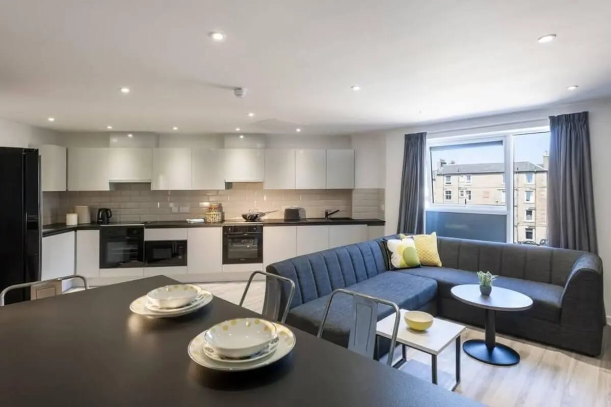 Modern kitchen with sofa and dining table living room at New Park in Edinburgh Student Accommodation