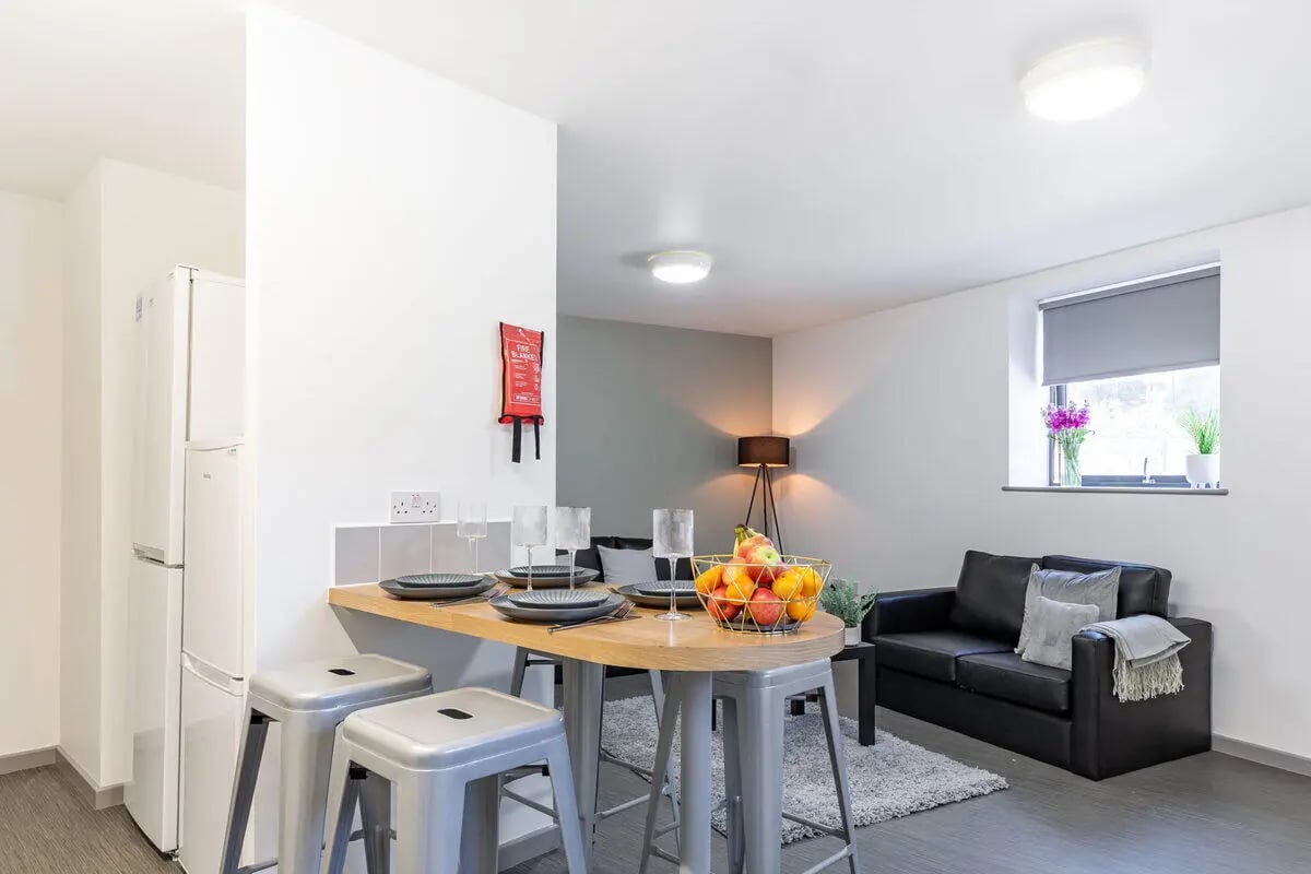 Fridge counter stools fruit bowl sofa living area at Turner Court in Newcastle Upon Tyne Student Accommodation