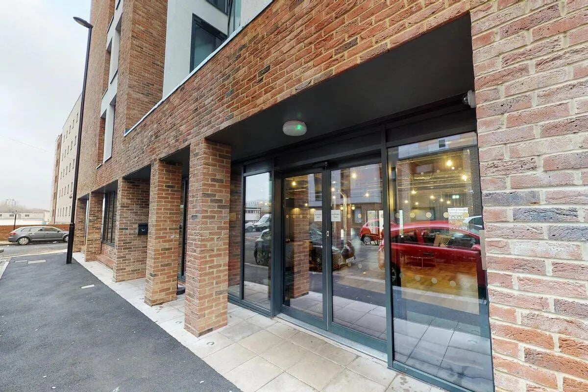 Glass doors brick building exterior at The Bridge in Newcastle Upon Tyne Student Accommodation