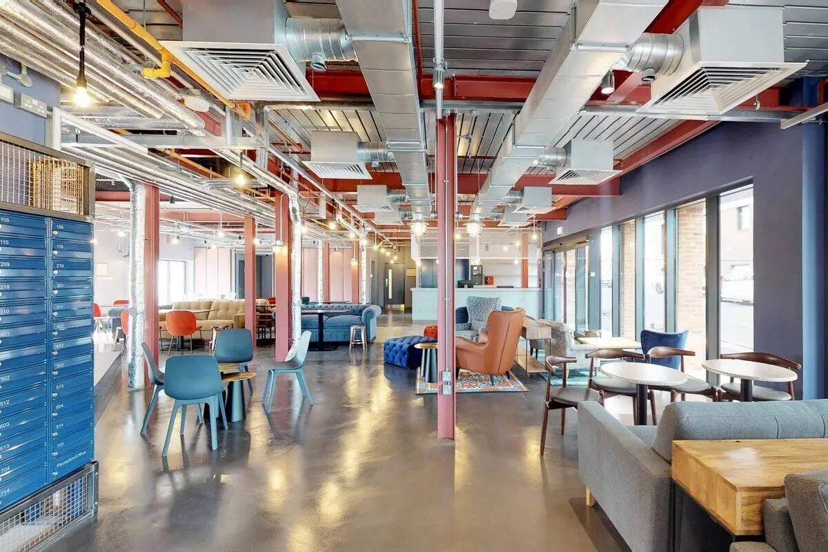 Blue mailboxes chairs sofas tables communal area at The Bridge in Newcastle Upon Tyne Student Accommodation