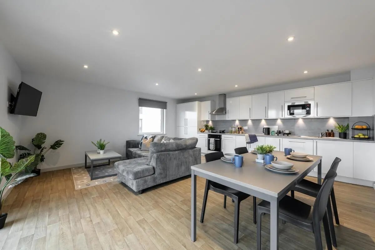 Sofa kitchen island dining table living room at The Bridge in Newcastle Upon Tyne Student Accommodation