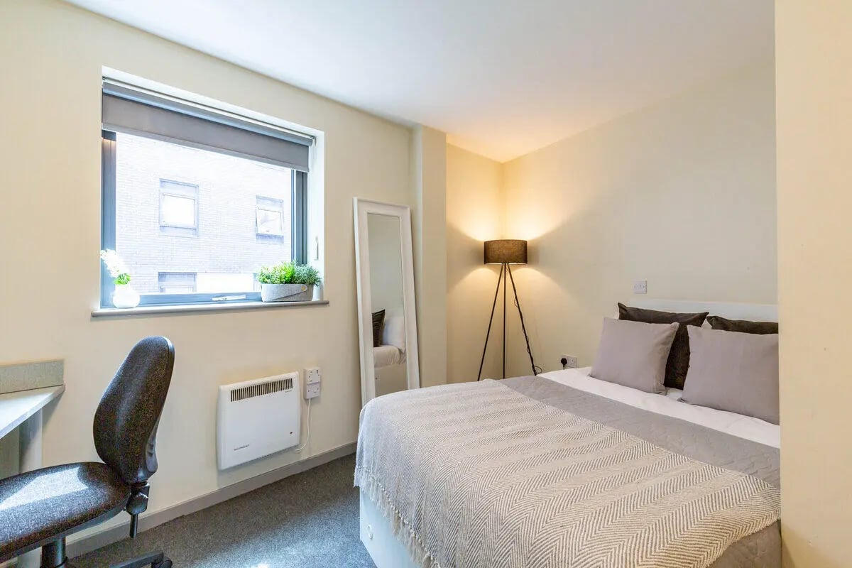 Bed desk heater mirror and floor lamp bedroom at Bryson Court in Newcastle Upon Tyne Student Accommodation