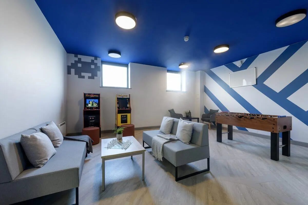 Arcade games foosball table sofas living room at Rosedale Court in Newcastle Upon Tyne Student Accommodation