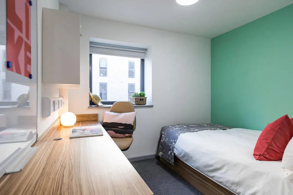 Bed desk lamp and pillow student bedroom at Rosedale Court in Newcastle Upon Tyne Student Accommodation
