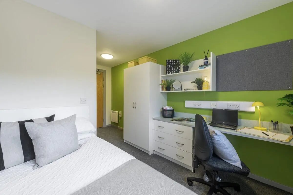 Bed desk wardrobe with plants and laptop bedroom at Marshall Court in Newcastle Upon Tyne Student Accommodation