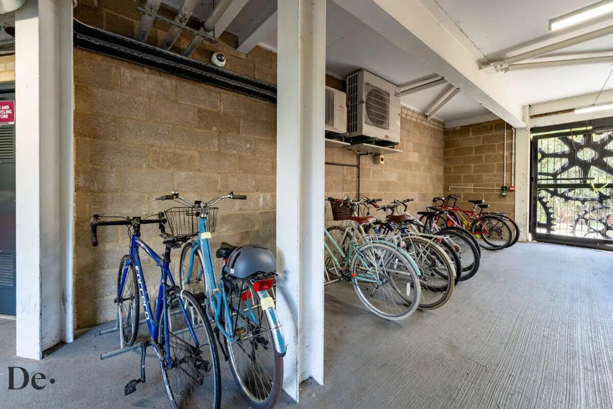 Bicycles in racks exterior storage area at Castle Hill in Cambridge Student Accommodation