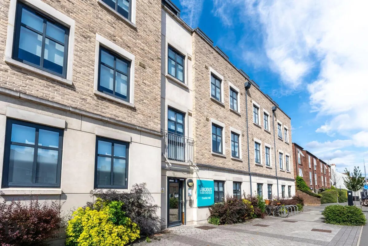 Modern brick student accommodation building with balconies exterior at Castle Hill in Cambridge Student Accommodation