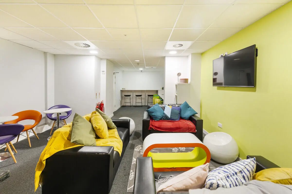 Modern communal space with sofas and tables living room at Tamarillo House in Bristol Student Accommodation