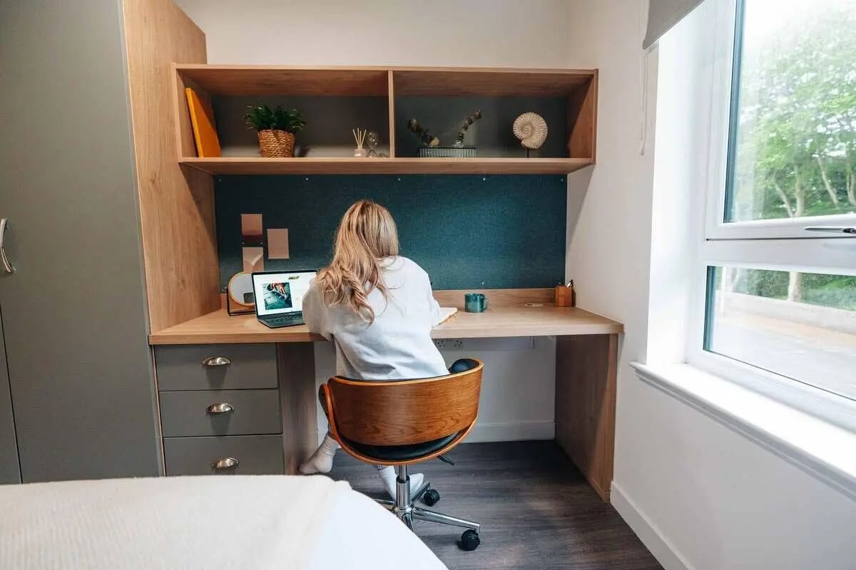 Student studying at desk with laptop study area at Caledon Court in Aberdeen Student Accommodation