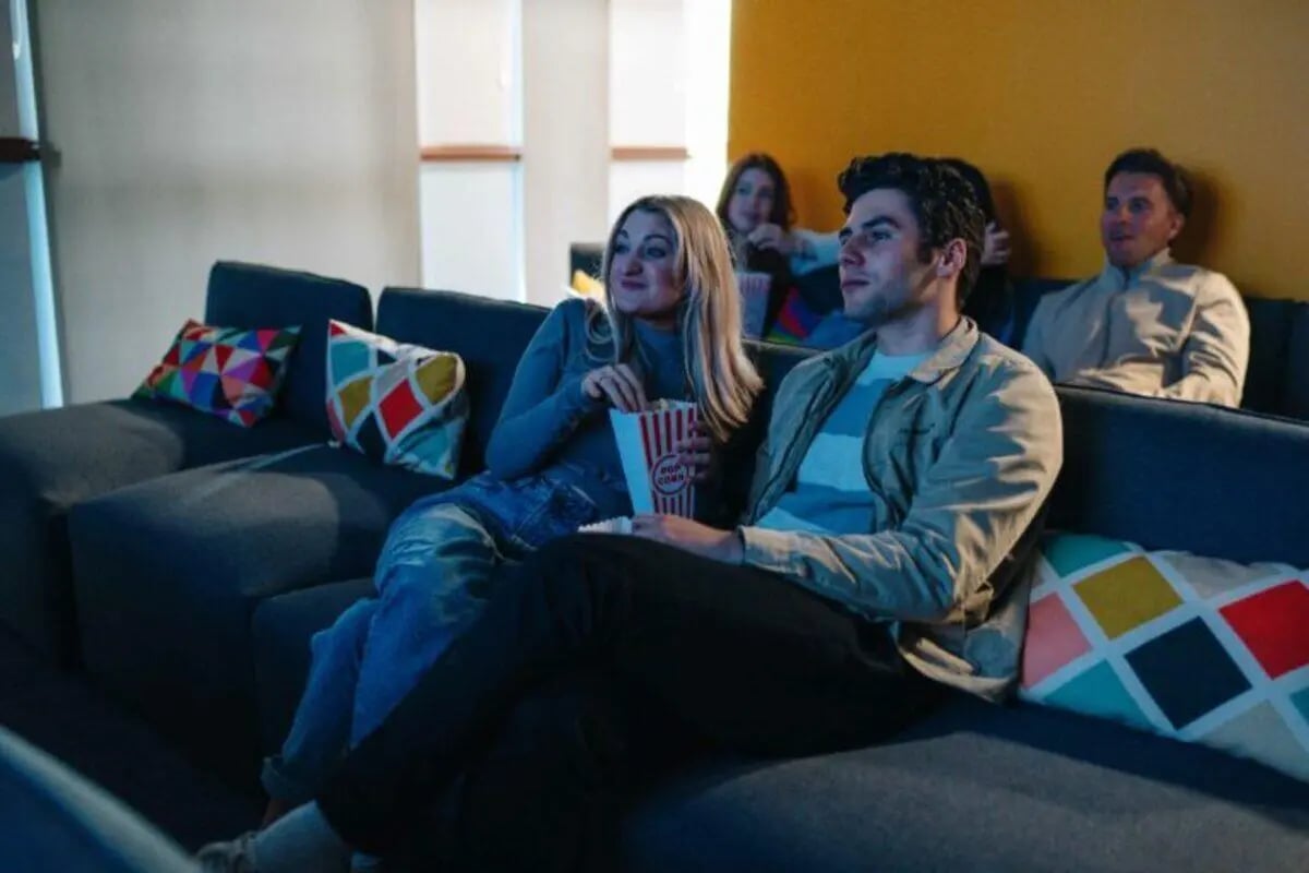 Students on couch watching movie living room at Caledon Court in Aberdeen Student Accommodation