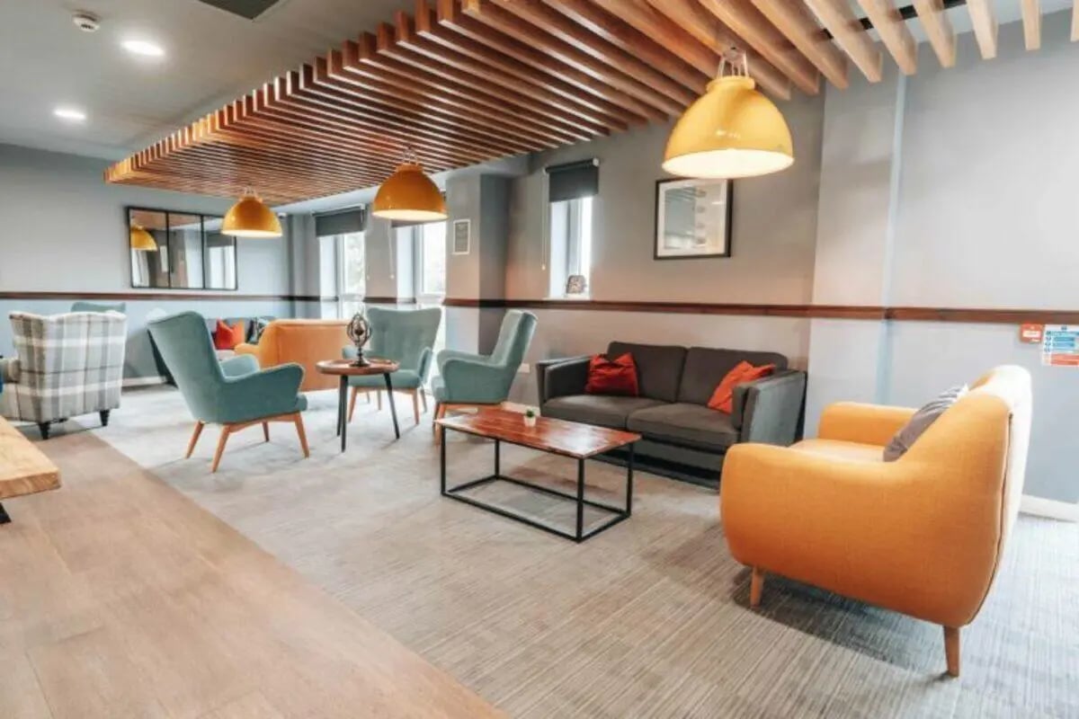 Sofa chairs coffee table and lamps common area at Caledon Court in Aberdeen Student Accommodation