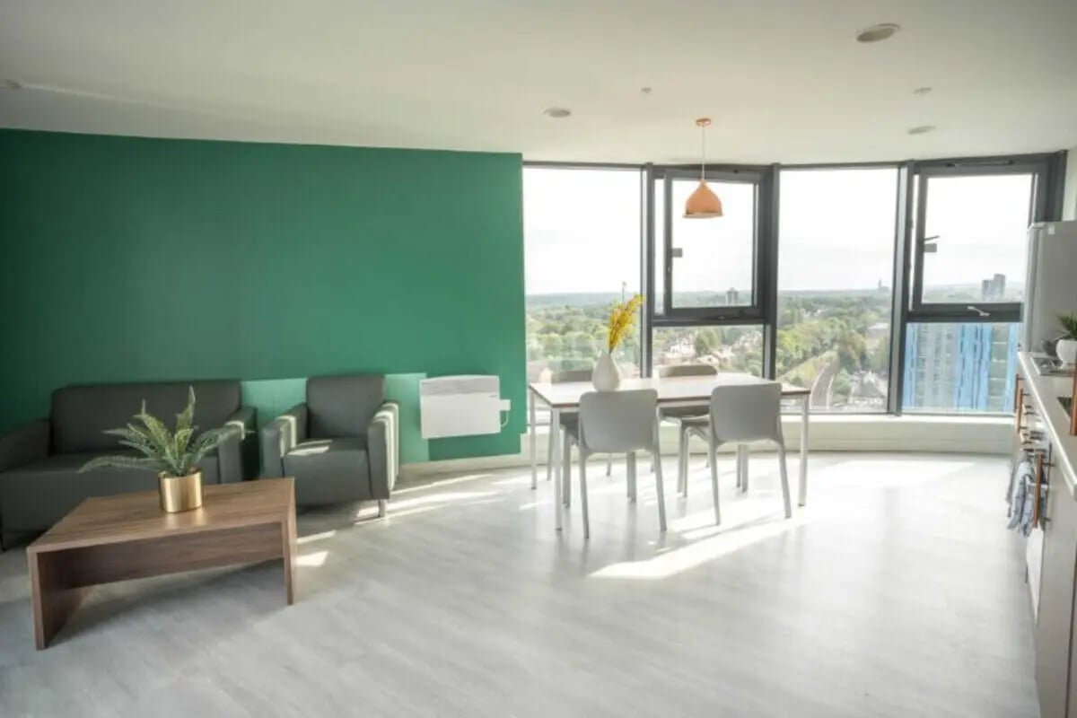 Sofa dining table chairs with view living room at The Toybox in Birmingham Student Accommodation