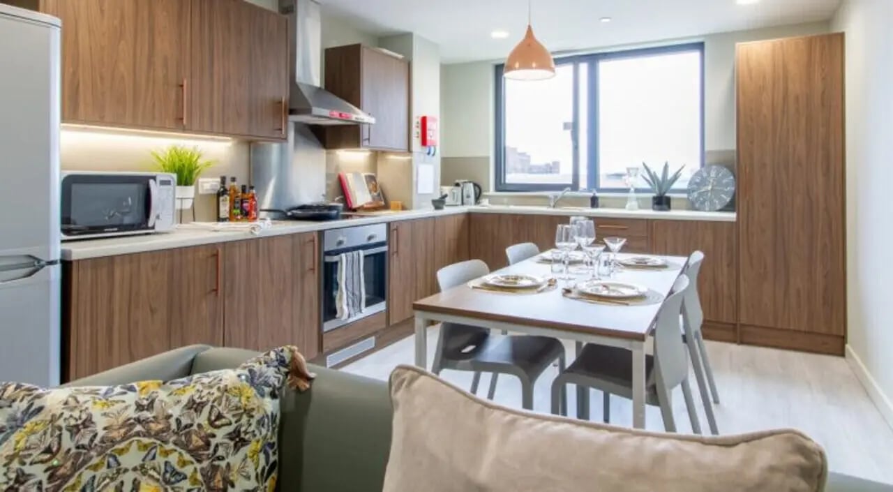 Dining table and kitchen cabinets student accommodation kitchen at The Toybox in Birmingham Student Accommodation