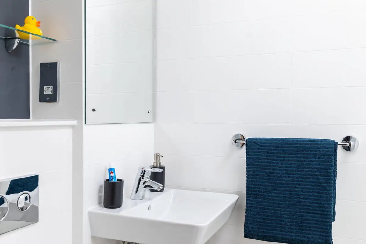 Sink faucet soap dispenser toothpaste towel rack bathroom at West Wing in Cardiff Student Accommodation