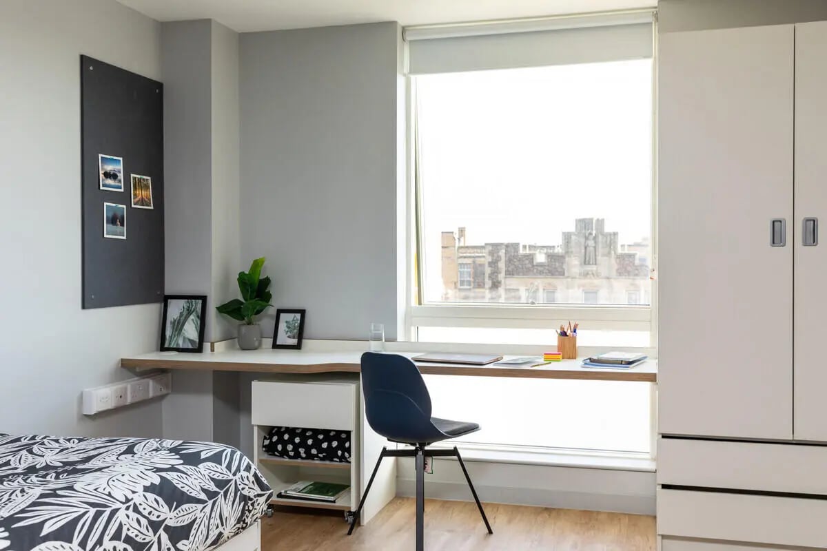 Desk plant chair and wardrobe study area at West Wing in Cardiff Student Accommodation