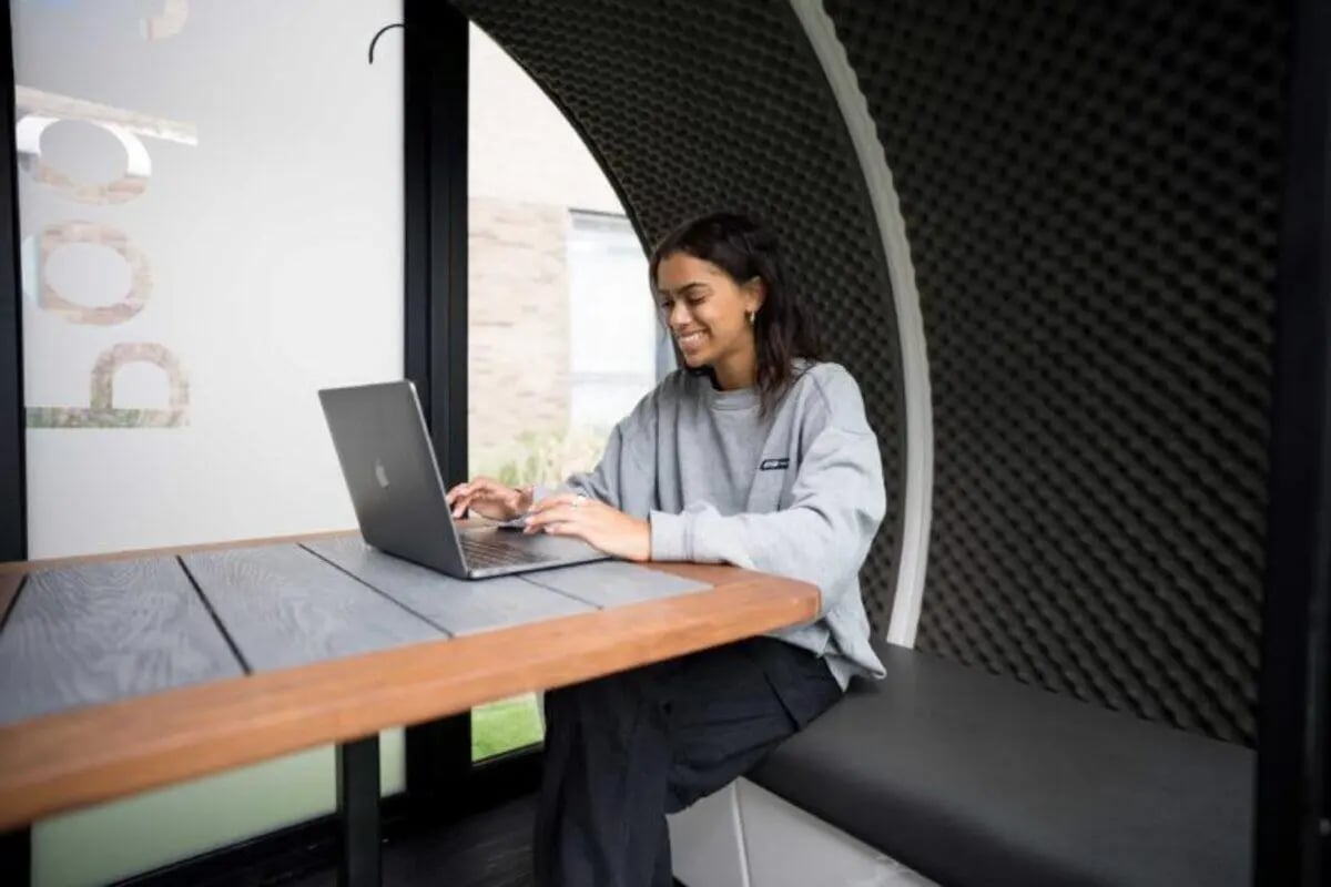 Woman working on laptop at desk study area at West Wing in Cardiff Student Accommodation