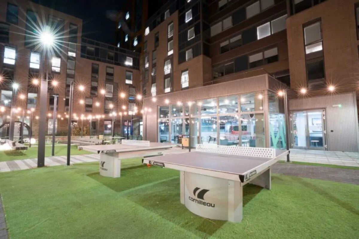 Ping pong tables on green turf communal area exterior at West Wing in Cardiff Student Accommodation