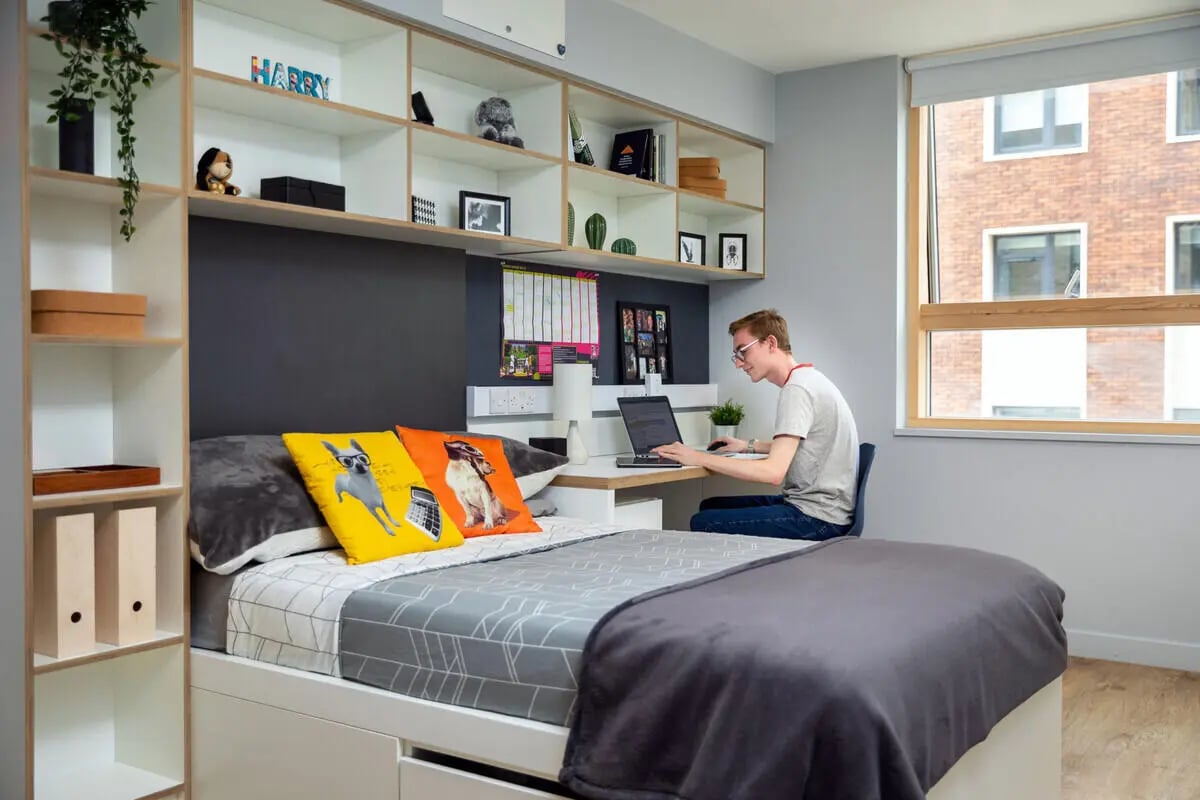 Student uses laptop at desk beside bed Bedroom at The Depot in Bath Student Accommodation