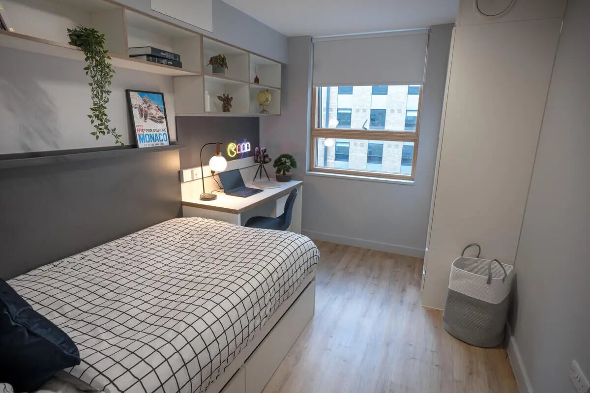 Bed desk shelf and laundry basket bedroom at The Depot in Bath Student Accommodation
