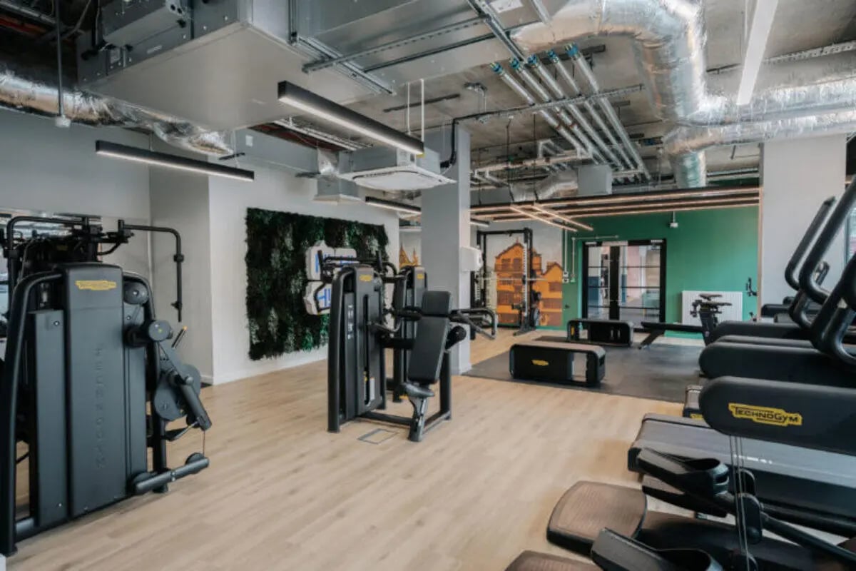 Gym equipment with green wall art living room at The Depot in Bath Student Accommodation