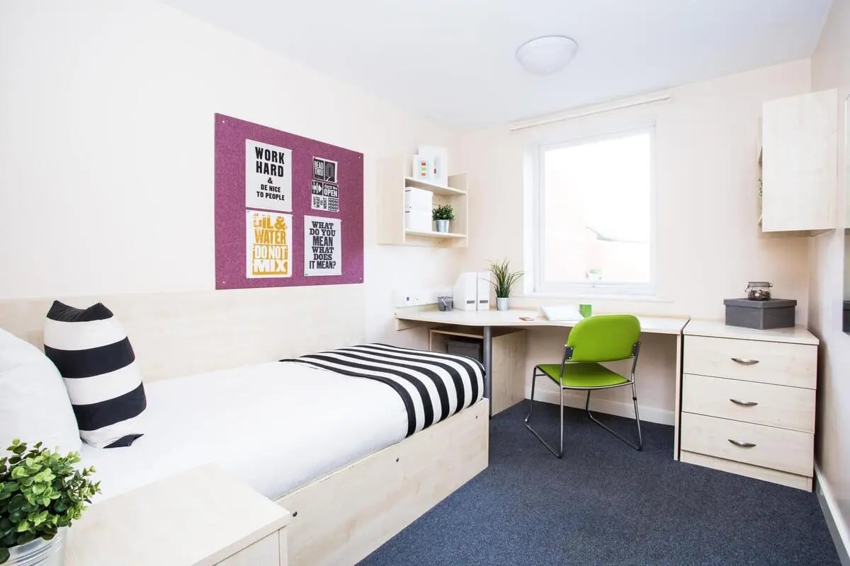 Bed desk chair and chest of drawers bedroom at The Grange Leicester in Leicester Student Accommodation