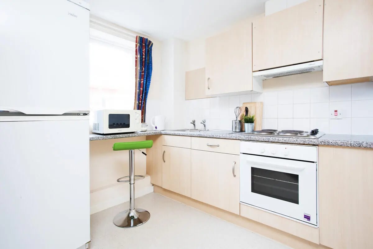 White fridge microwave oven stovetop sink kitchen at The Grange Leicester in Leicester Student Accommodation