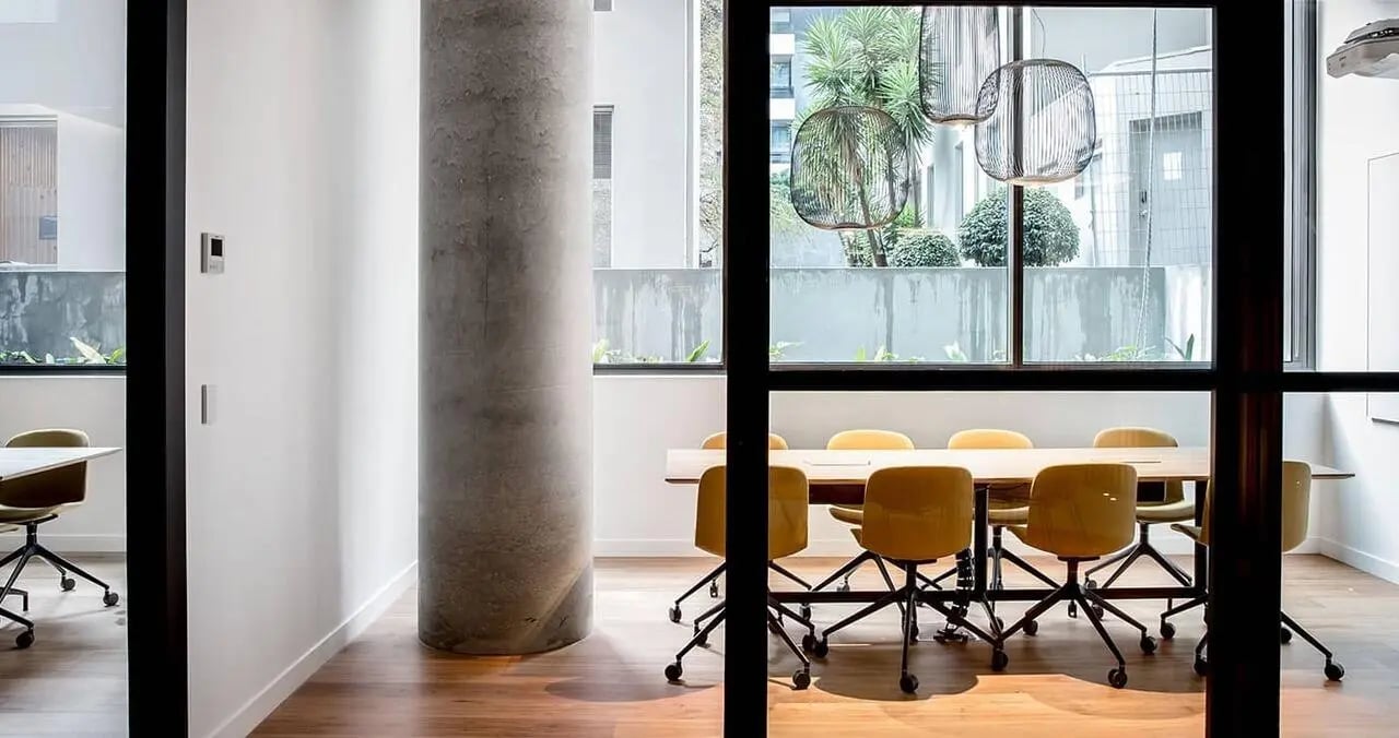 Conference table and yellow chairs meeting room at Iglu South Yarra in Melbourne Student Accommodation