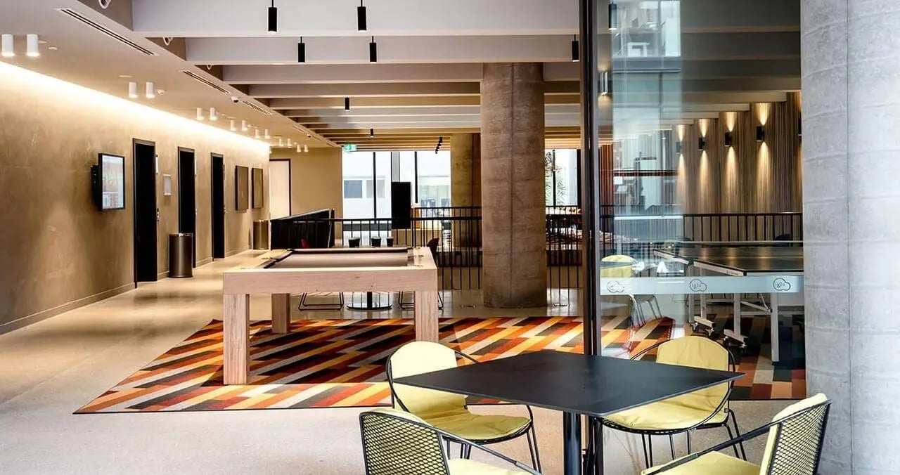 Billiard table ping pong table chairs lounge area at Iglu South Yarra in Melbourne Student Accommodation