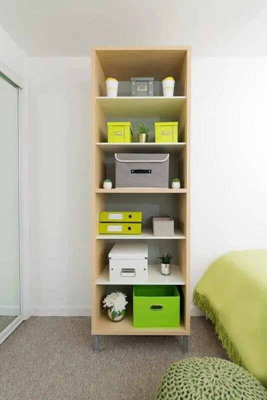 Shelf with storage boxes binders and plants bookshelf storage at Trinity Court in Aberdeen Student Accommodation